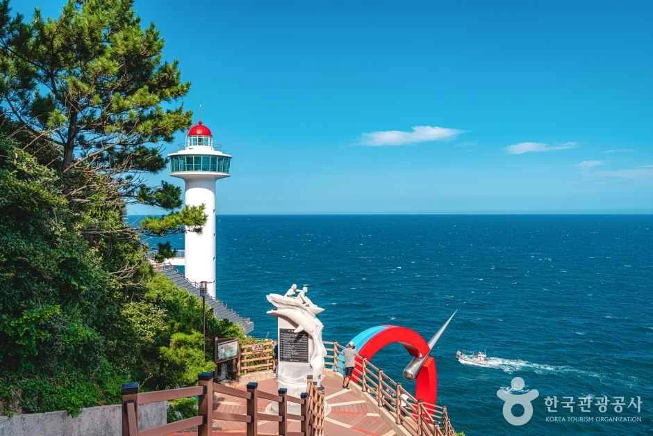 Steps and a viewing area beside the white Yeongdo Lighthouse, overlooking the sea